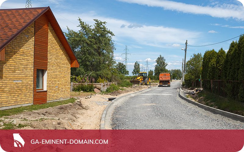 A road being built only a few feet from a home.